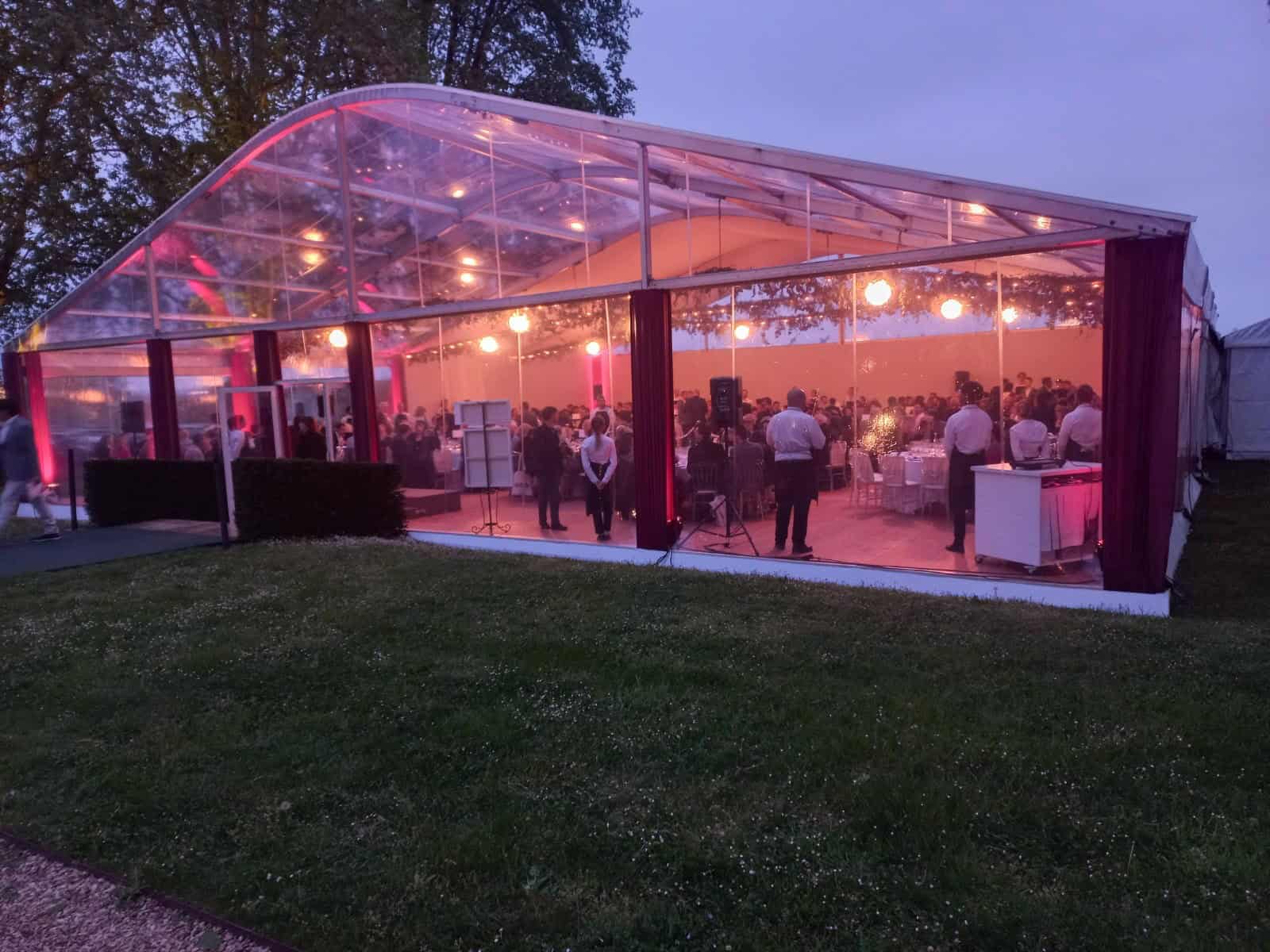 Transparent event tent illuminated at Bellefont Belcier Castle.