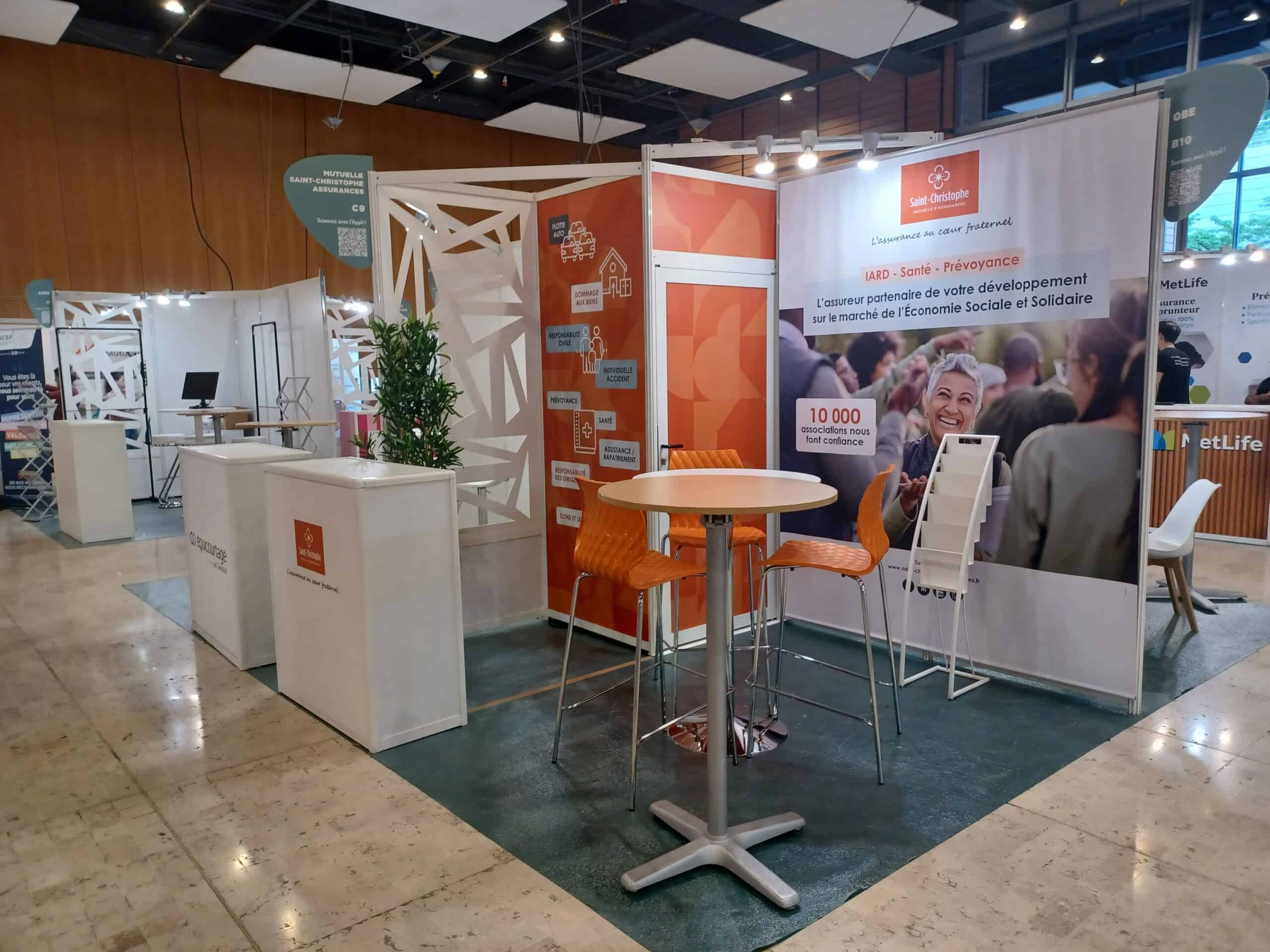Co-Nect booth at brokerage event with informational banners and seating area.
