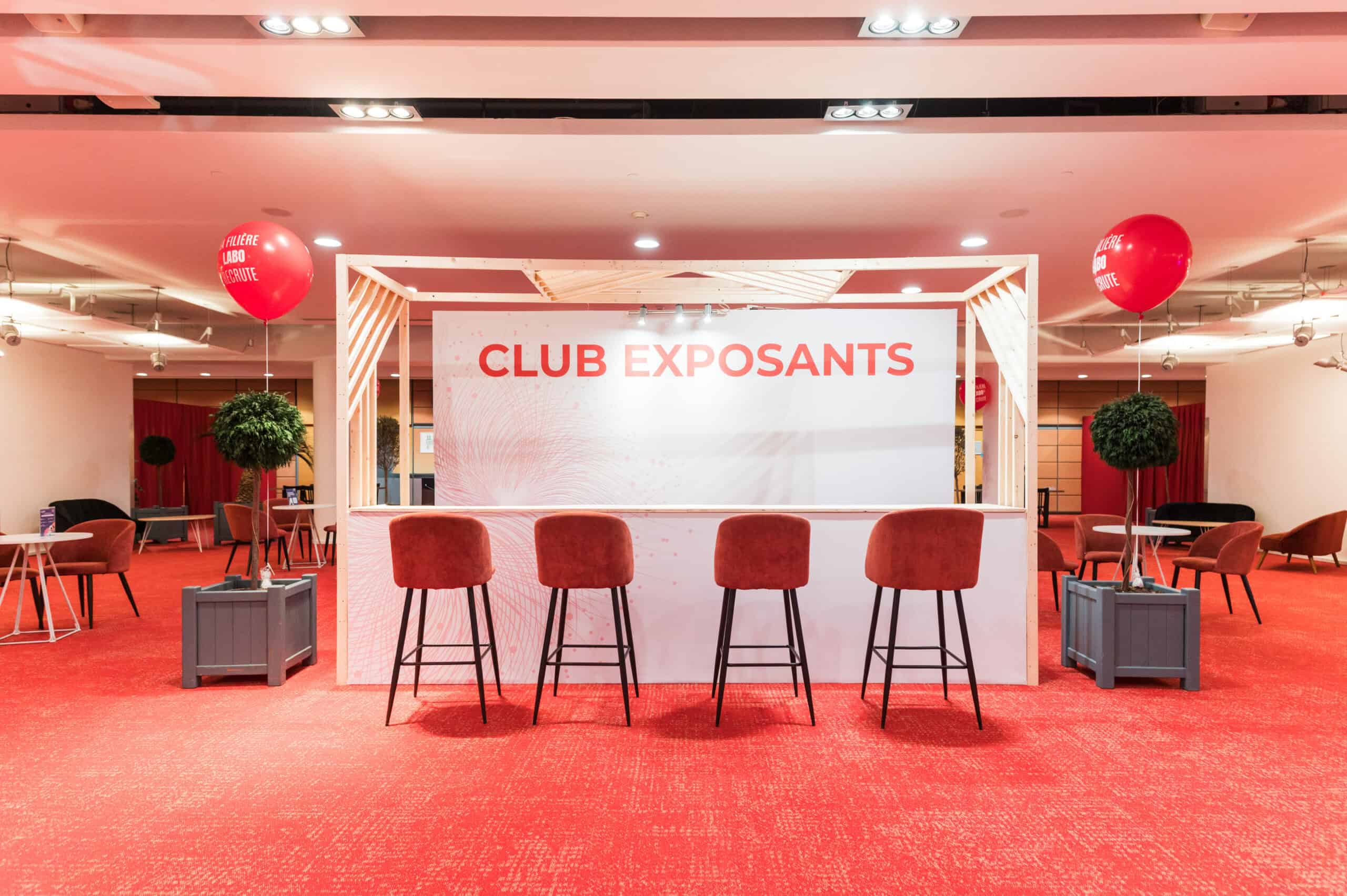 Club Exposants event setup with a stage and seating area in a conference hall.