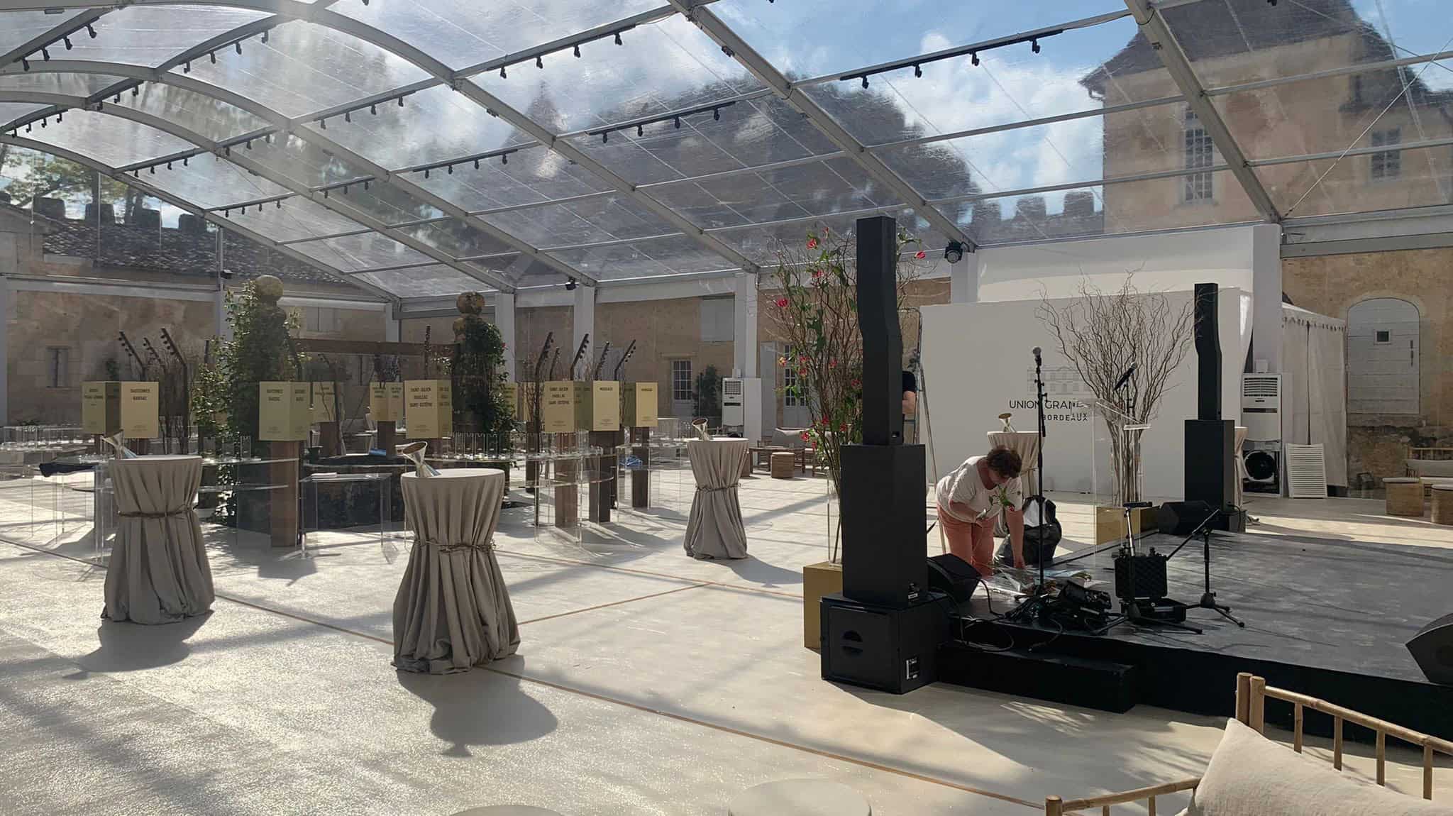 Event setup at Château Yquem with sound system and high tables.