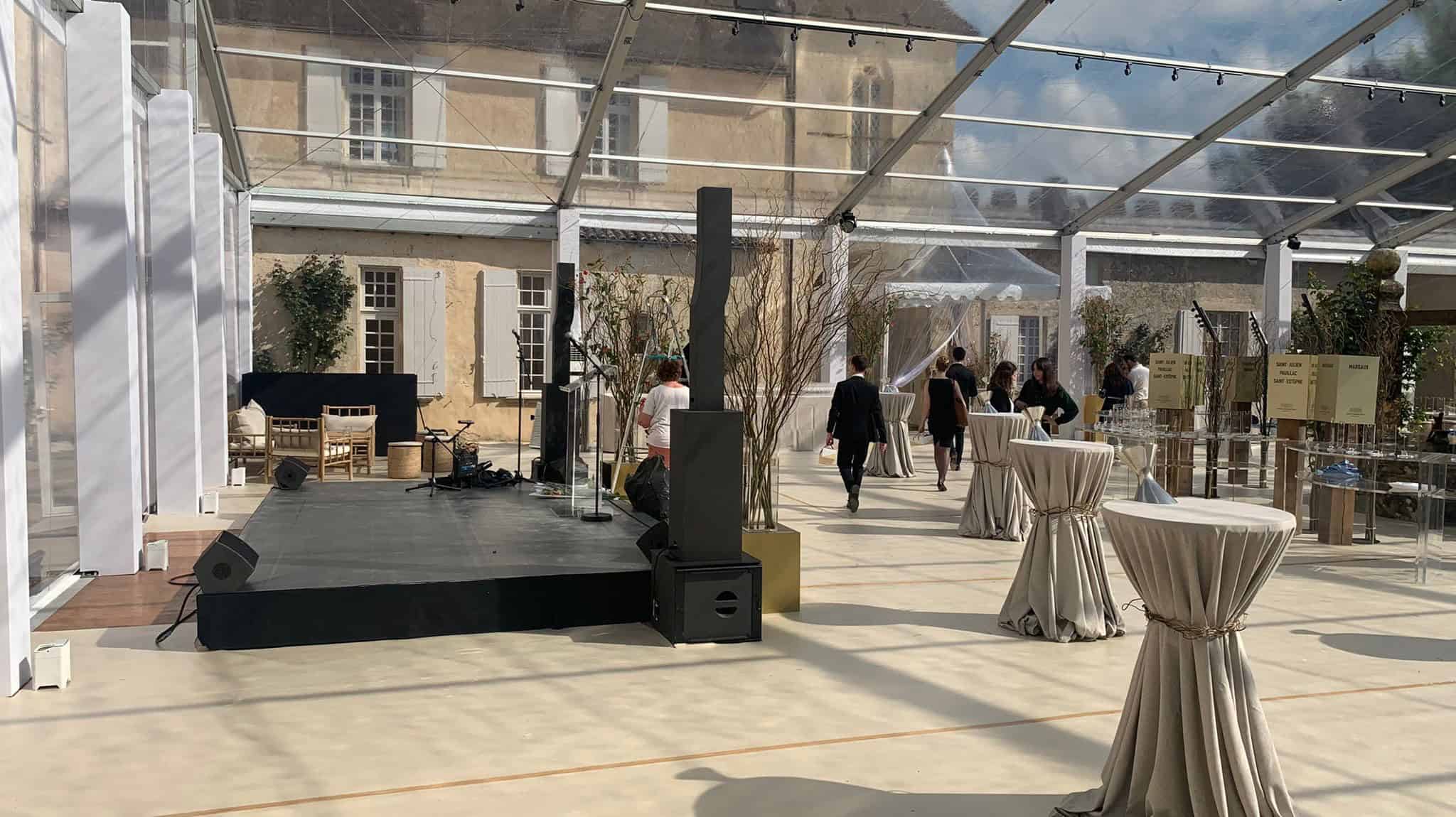 Elegant event setup at Château Yquem with stage and seating.