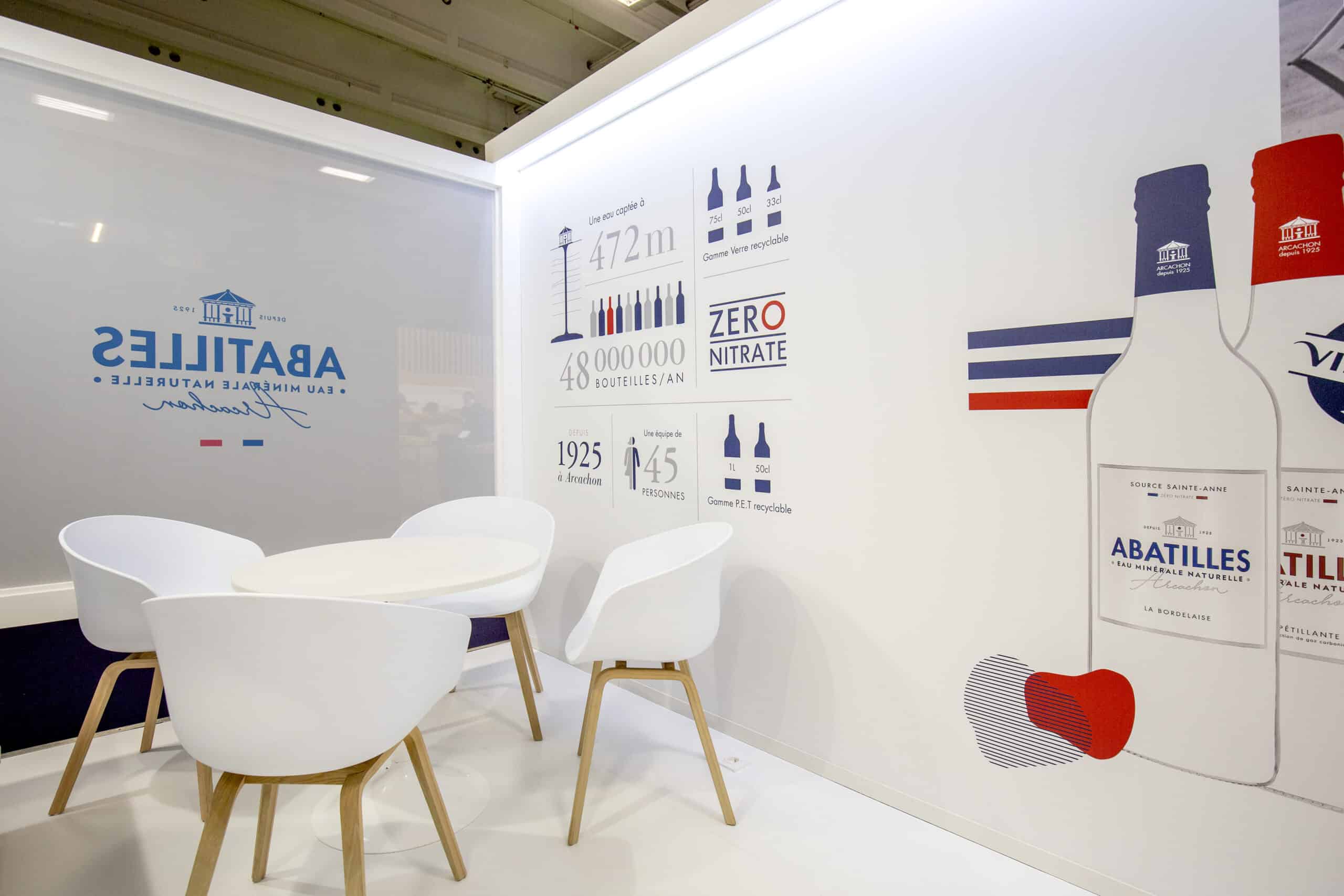 Display of Abatilles bottled water with branding and product details at Co-Nect event.