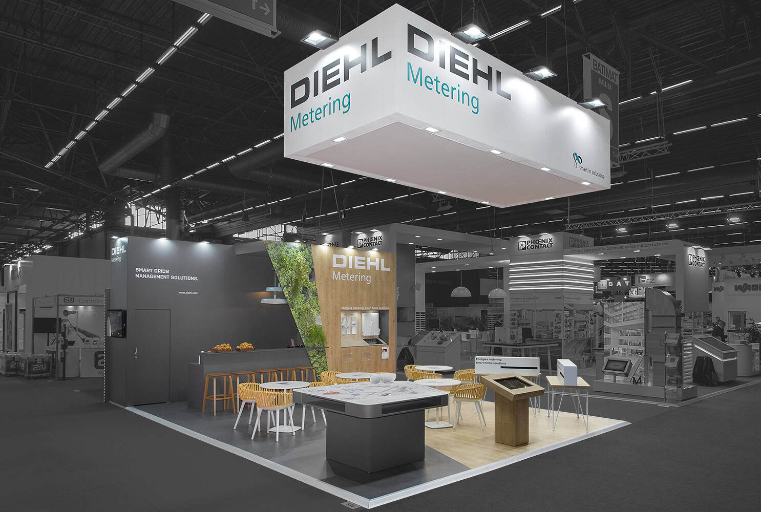 Diehl Metering booth at trade show with seating and display areas.