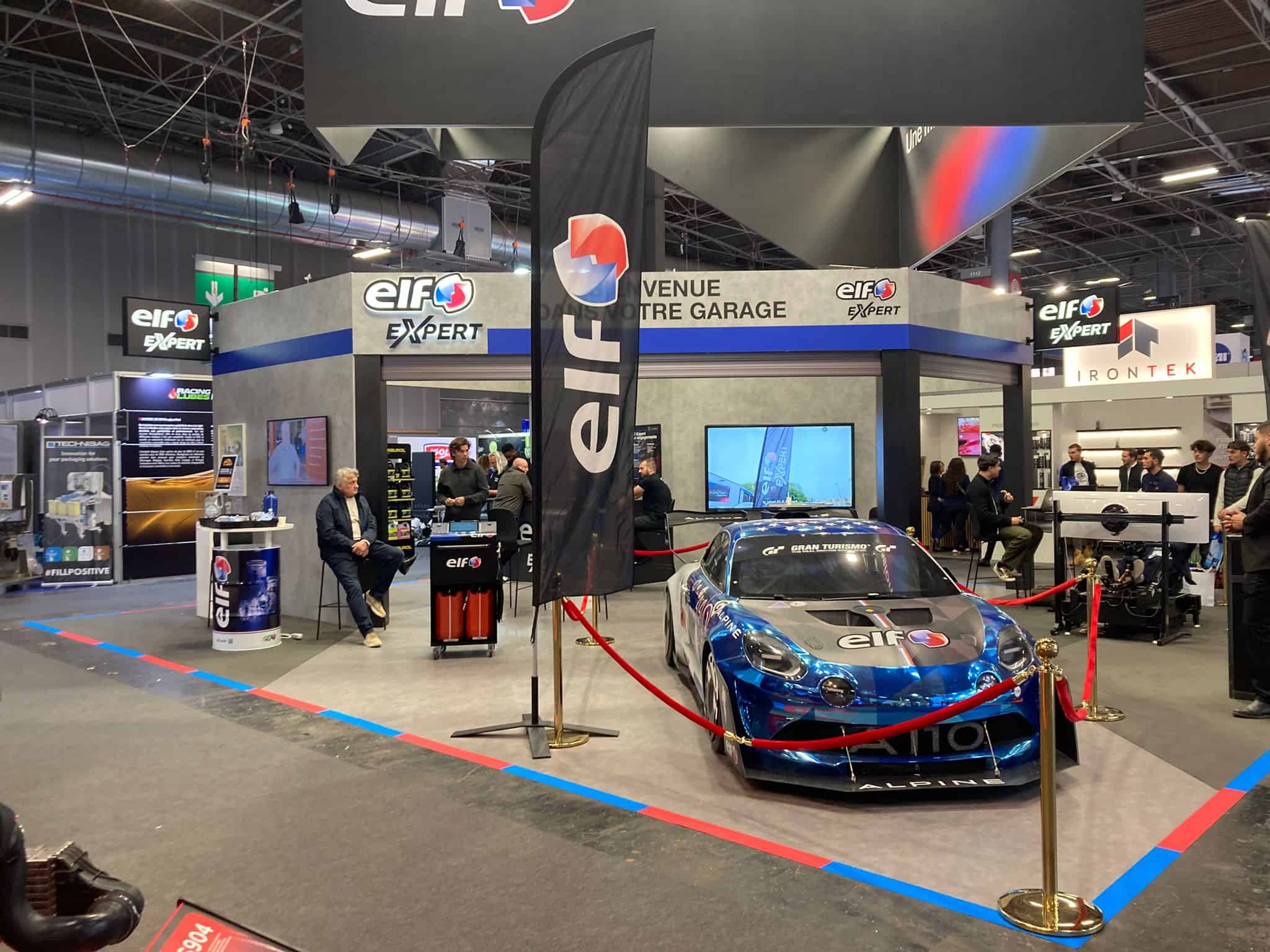 ELF Expert booth featuring a race car at an event.