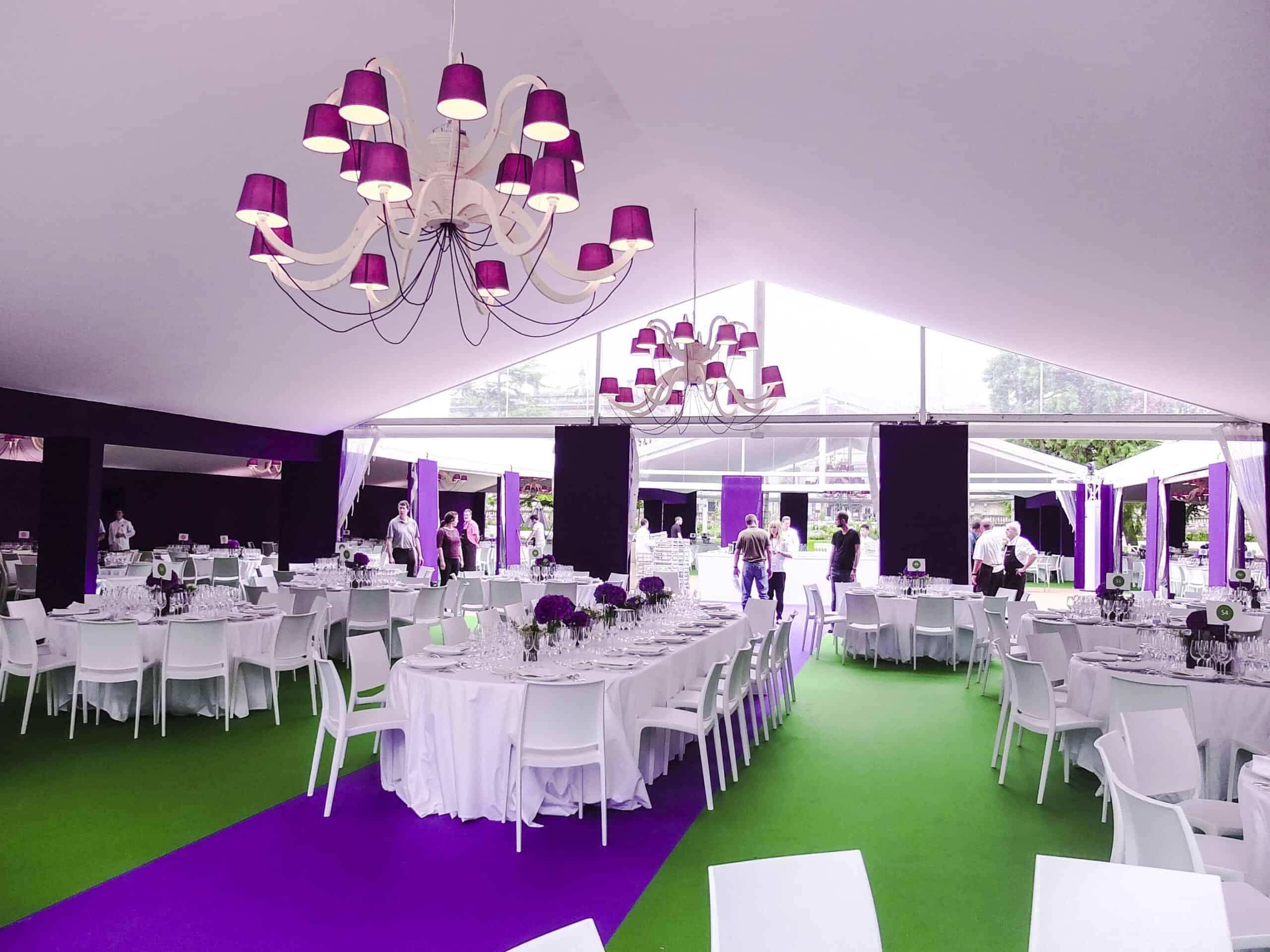 Elegant event tent decorated with purple and white accents for a flower festival.