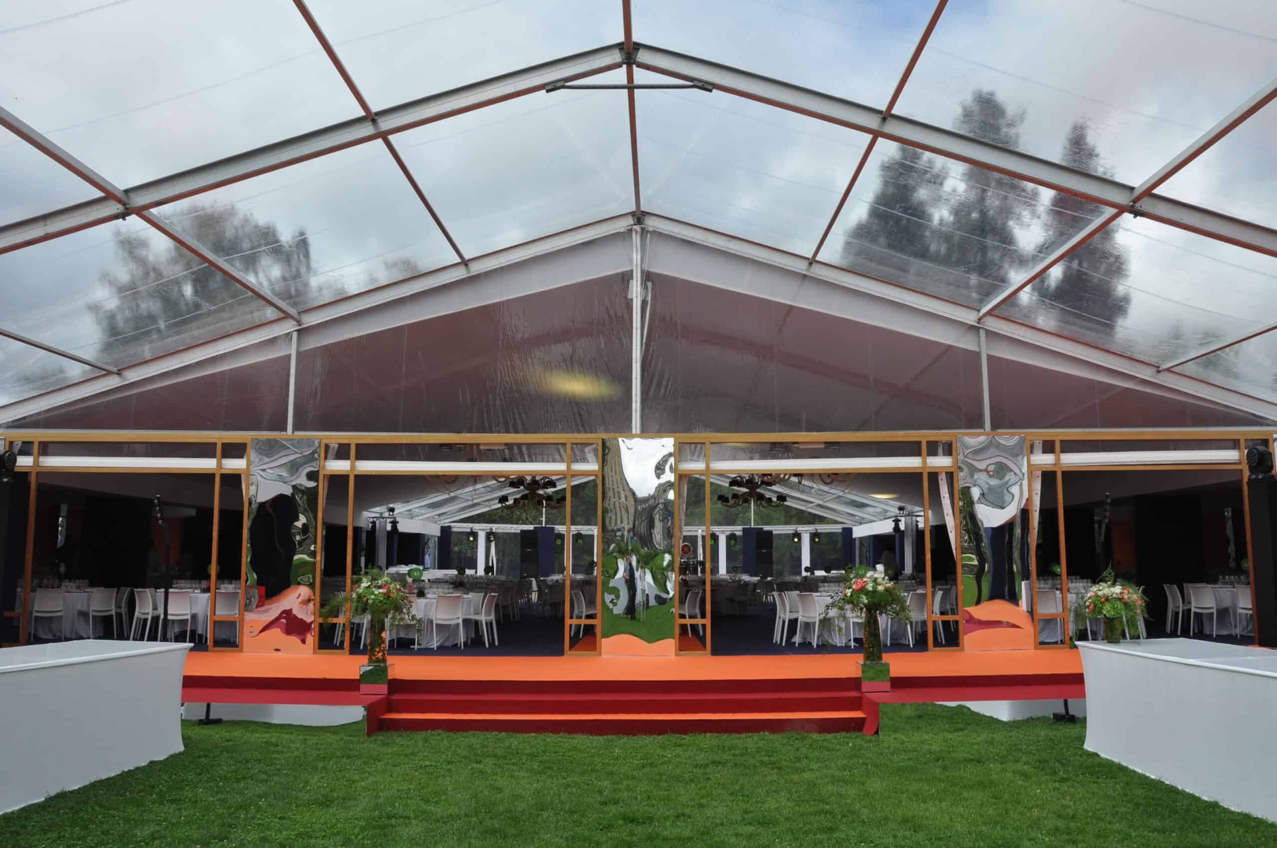 Elegant event tent setup with floral decorations for a flower festival.