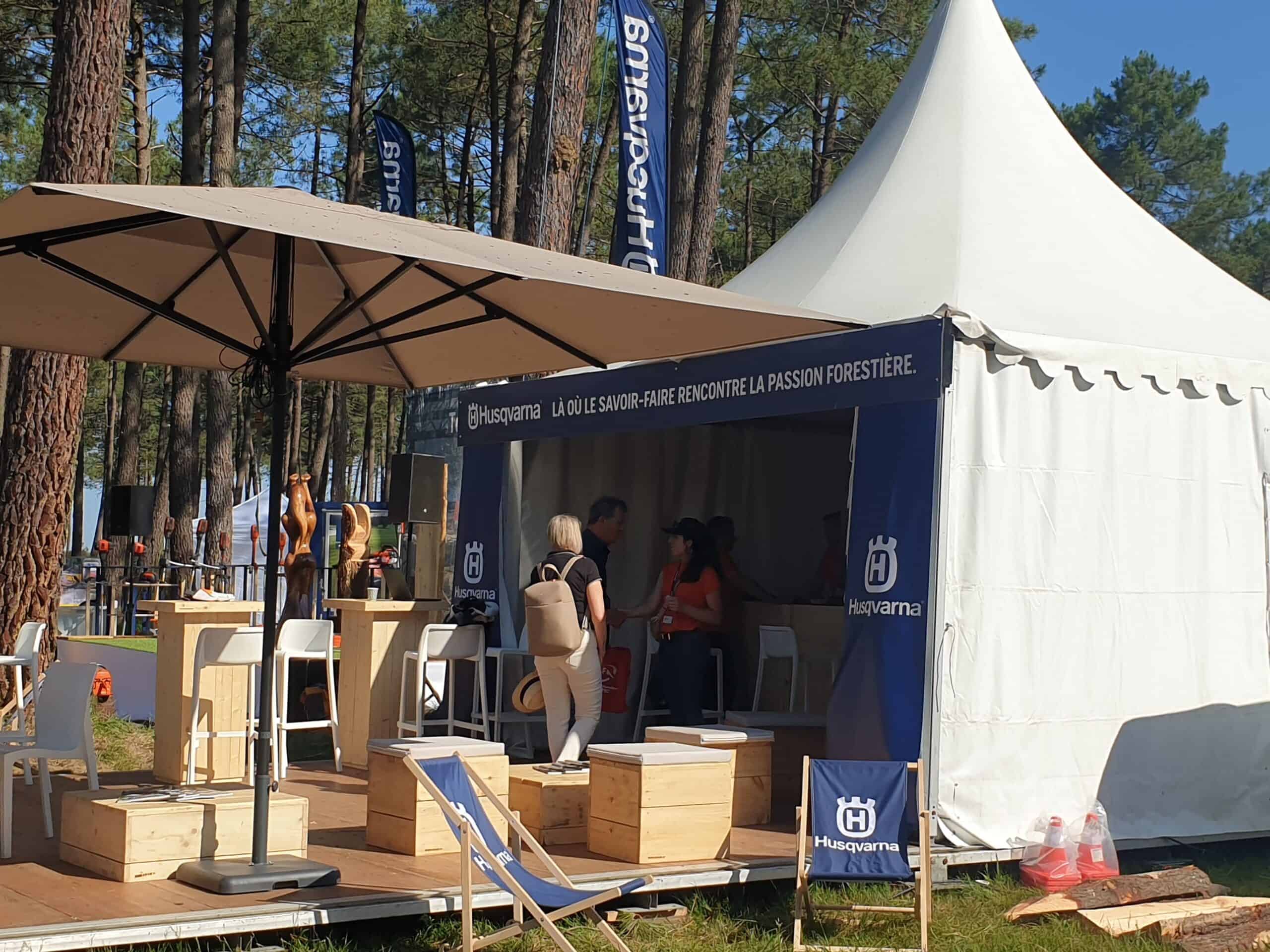 Co-Nect booth at FOREXPO forestry event with tent and seating area.
