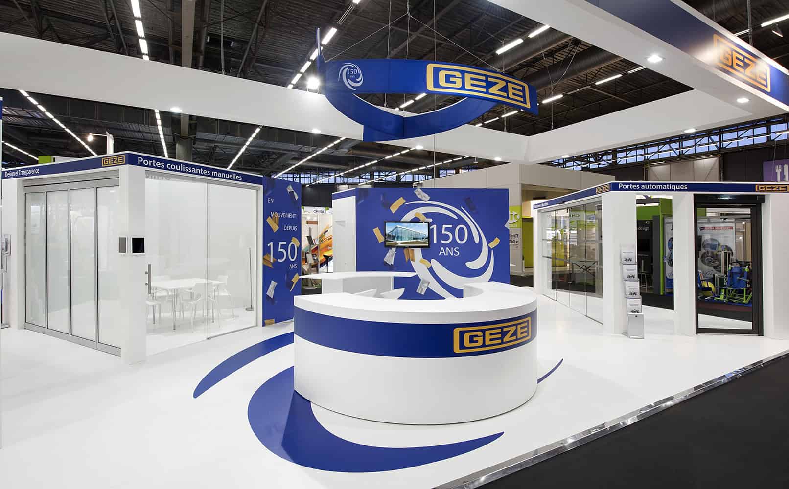 Geze booth showcasing automatic doors and security solutions at trade show.