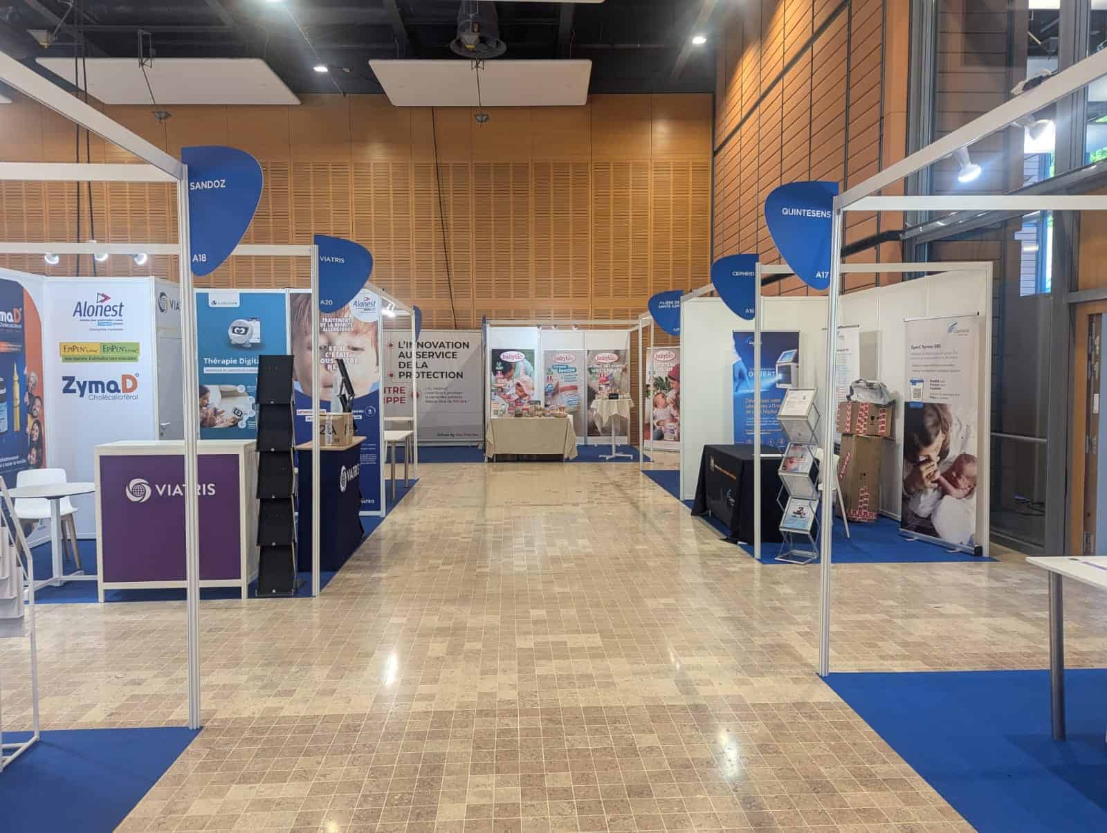 Exhibition hall at Pediatric Conference with various medical booths and displays.