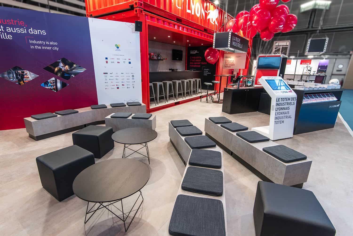 Modern industrial hub in Lyon with seating and information displays.