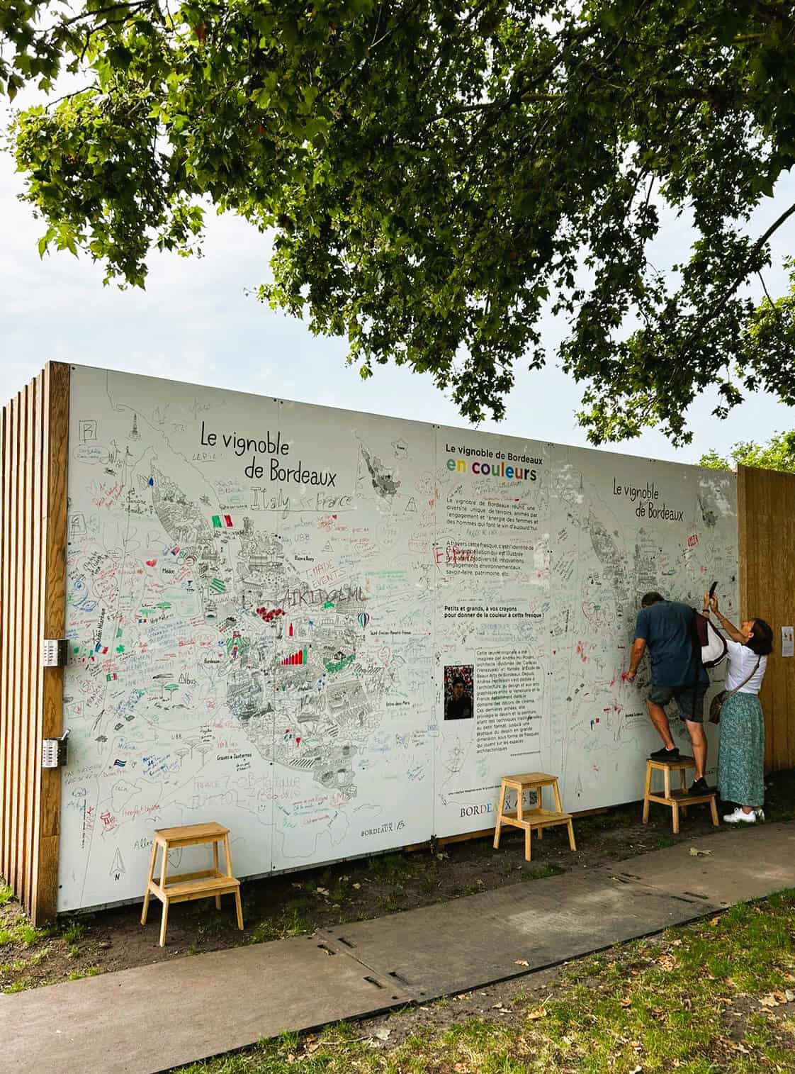Bordeaux wine festival map display with visitors writing on it.