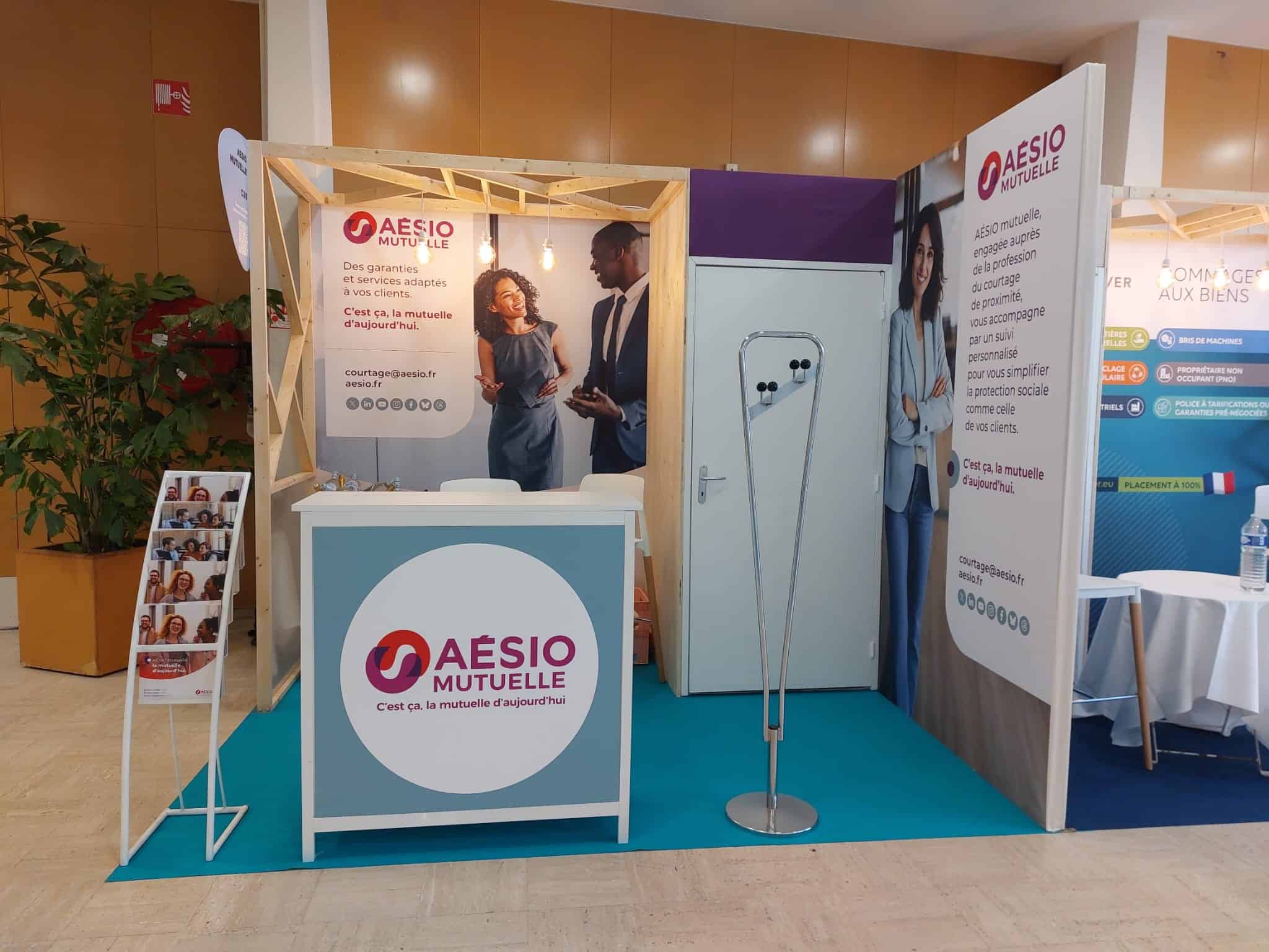 Aesio Mutuelle booth at a brokerage event showcasing insurance services.
