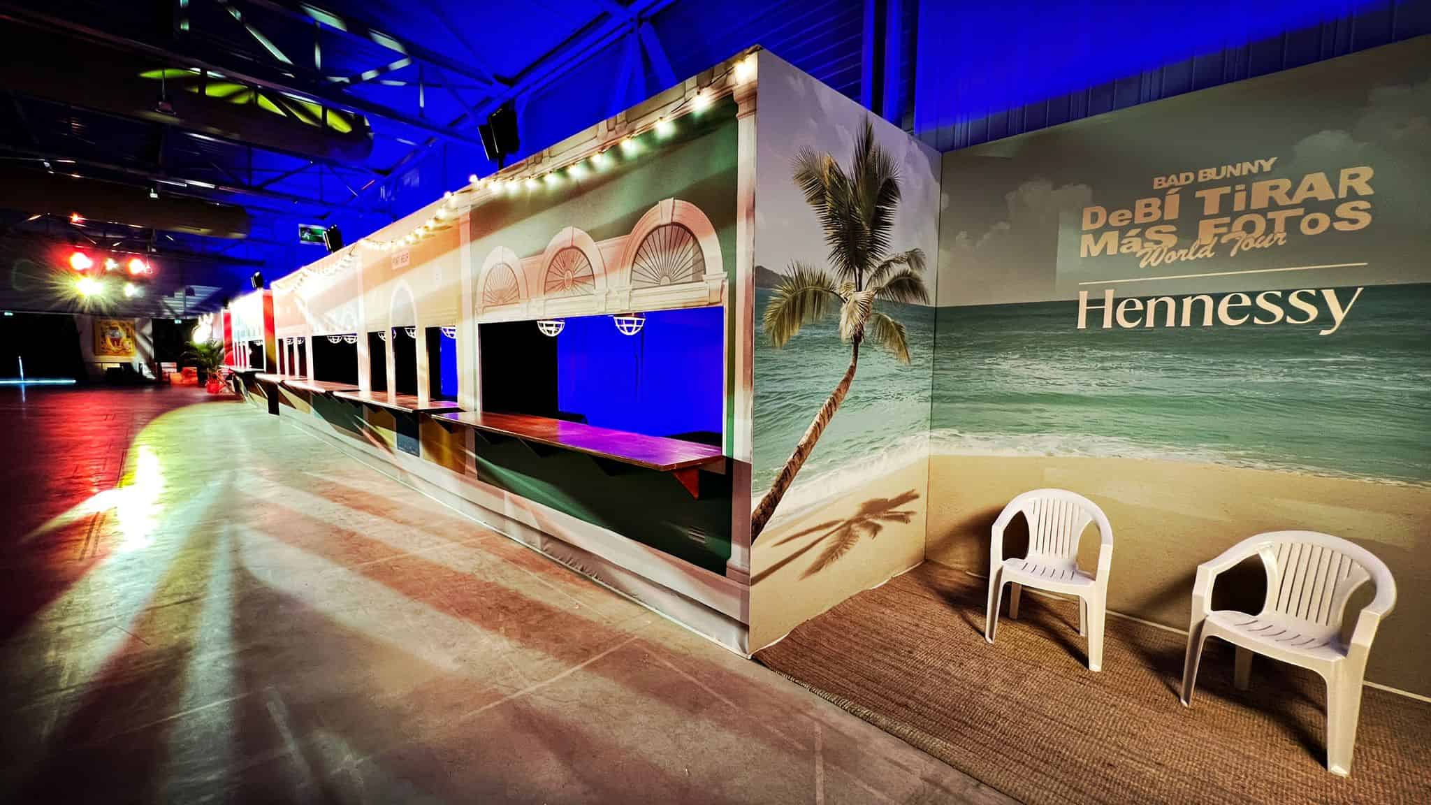 Hennessy booth at the Co-Nect event with beach-themed decor and seating area.