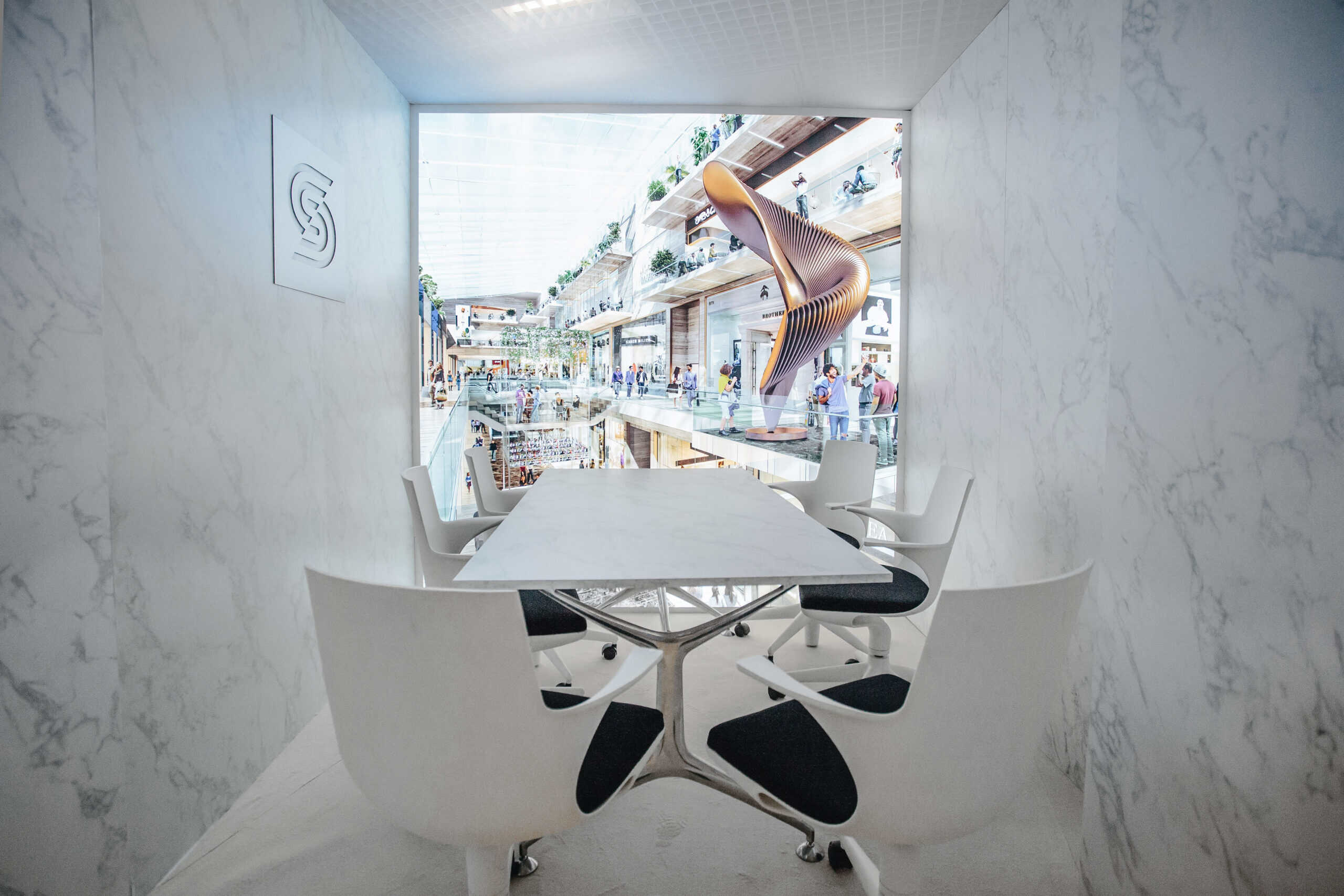 Contemporary meeting room with white chairs and a large window view.