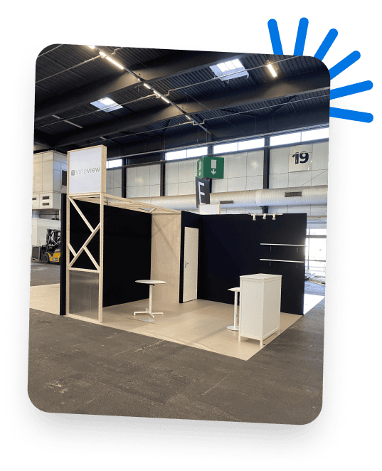 Co-Nect exhibition booth at a trade show with modern design elements.