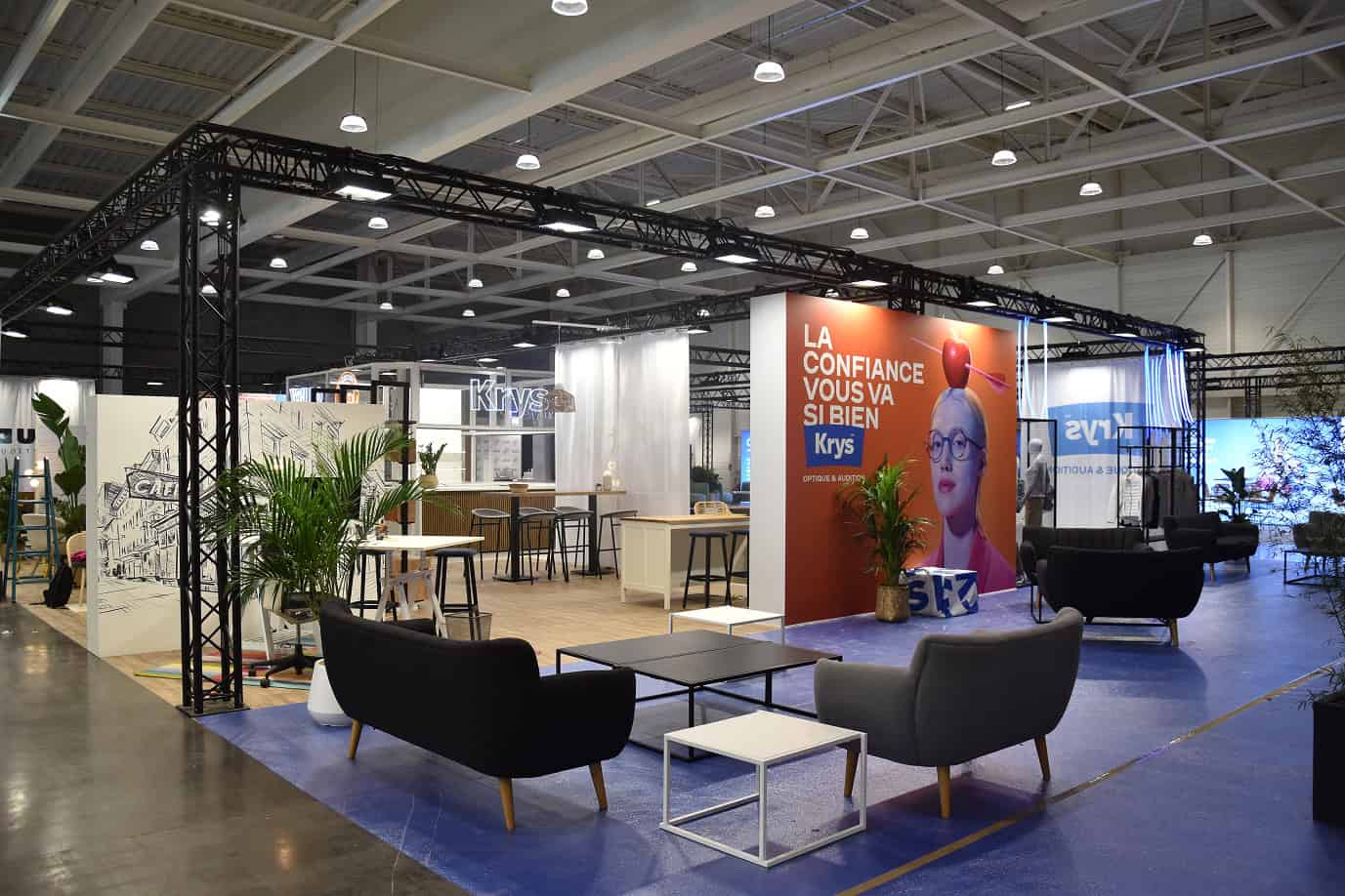 Co-Nect exhibition booth at a trade show with seating and branding displays.