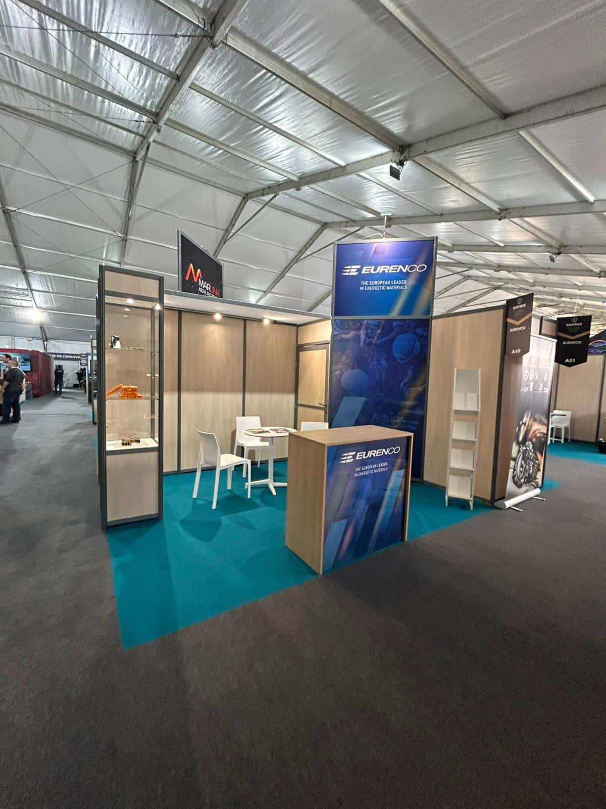 Co-Nect booth at Sofins trade show with branding and seating area.