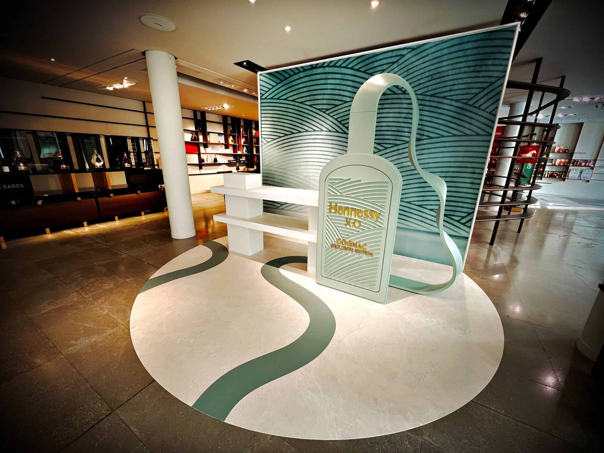 Co-Nect promotional display with large headphone and lock icon in modern interior.